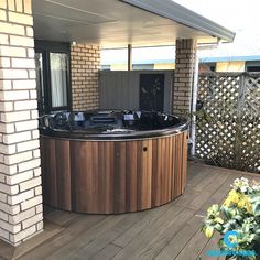 a hot tub sitting on top of a wooden deck