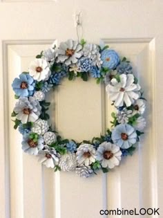 a white door with a blue and white wreath hanging on it's front door