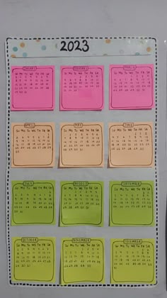 a calendar on a refrigerator door with magnets