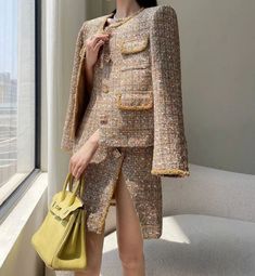 Elevate your style with this exquisite handmade gold tinsel tweed boucle jacket and mini dress set. Crafted with meticulous attention to detail, this ensemble exudes luxury and sophistication. The shimmering gold tinsel woven into the tweed fabric adds a touch of glamour, while the boucle texture provides depth and dimension to the pieces. The tailored jacket features a modern silhouette with structured shoulders and a flattering fit, perfect for adding a touch of elegance to any outfit. Paired Elegant Tweed Jacket For Party, Elegant Party Tweed Jacket, Tweed Boucle Jacket, Boucle Jacket, Tweed Fabric, Tailored Jacket, Handmade Gold, Handmade Fashion, High End Fashion