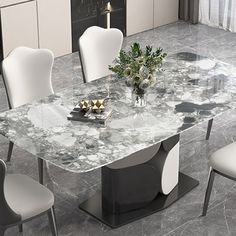 a marble dining table surrounded by white chairs