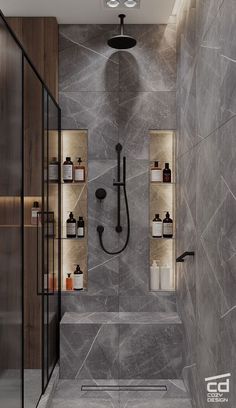 a bathroom with grey marble walls and flooring, shower head, shelves on the wall