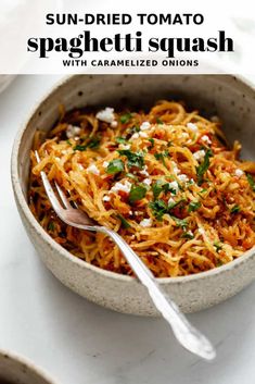 a bowl filled with spaghetti and topped with parsley