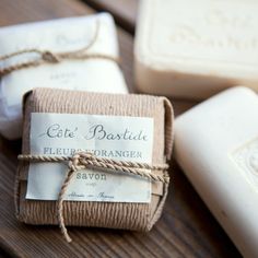 three soap bars wrapped in twine on top of a wooden table