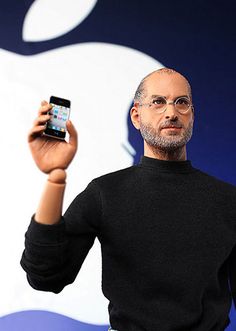 a man holding up an iphone in his hand