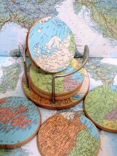 four wooden coasters with maps on them