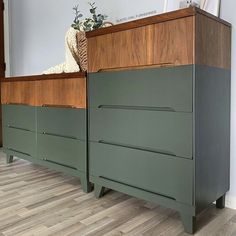 a green dresser sitting on top of a hard wood floor