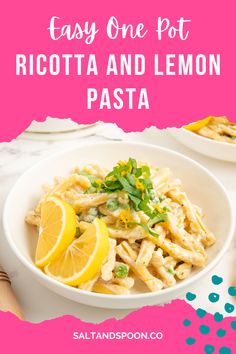 a white bowl filled with pasta and lemon slices