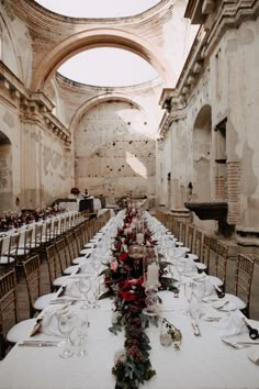 a long table is set up in an old building