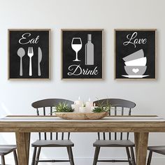 two black and white prints with the words eat, drink and love on them above a dining room table