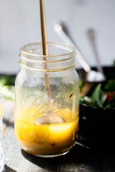 a mason jar filled with liquid sitting on top of a table