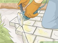 a person using a tile saw to cut up bricks on the ground with a power tool