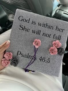 someone is holding up a graduation cap with roses on it that says, god is within her she will not fall