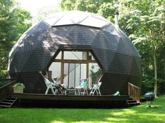 a large round house sitting on top of a lush green field