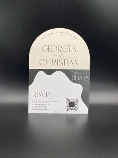 a white and black business card with the words, george and christian on it's front