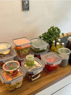 there are many plastic containers with food in them sitting on the counter next to each other