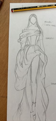 a pencil drawing of a woman's dress on top of a piece of paper