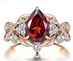 a ring with a large red stone surrounded by white diamonds