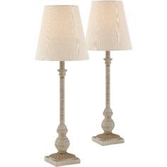 two white lamps with beige shades on them