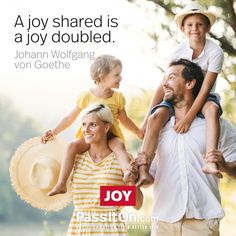 a man and woman holding two children while standing next to each other with the words joy shared is a joy doubled