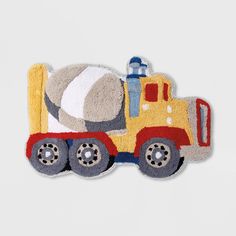 a toy truck with a cement ball on the back is sitting in front of a white background