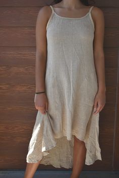 "We're inspired by sustainable hemp clothing that puts the earth and the people that make it first. Our personal relationship with our manufacturer in India allows us to stay true to what is important. Using organic materials, sustainable production, and fairly compensating our skillful tailors. You can wear this hemp dress anywhere or anytime and feel great wearing it. Included in every dress is our belief for a more sustainable and fair future.  Buy HEMP - heal the planet. 🌱 FEATURES ✔️Spaghetti straps ✔️Scoop neck ✔️Tie in back ✔️Asymmetrical, short in front and long in back  ✔️Below the knee length ✔️Machine washable (separately on gentle cycle and hang dry) ✔️100% Hemp from Nepal 🌱 SIZING:  SMALL Bust 34\"-35\" Waist 28\"-32\" Hip 46\" Length 49\"  MEDIUM Bust 36\"-37\" Waist 29\"-3 Sleeveless Natural Color Summer Dress, Natural Sleeveless Summer Dress, Natural Color Sleeveless Summer Dress, Sleeveless Neutral Linen Midi Dress, Linen Beach Dress With Asymmetrical Hem, Beige Linen Sleeveless Dress For Beach, Short Spaghetti Strap Dress, Natural Fibers Clothing, Summer Dress Short