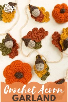 crocheted turkeys and acorns are hanging from twine strings on a white surface