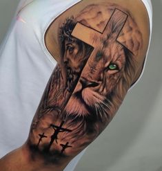 a man with a lion and cross tattoo on his arm