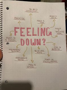 a notepad with writing on it that says feeling down and arrows pointing in different directions