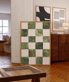 a living room with wood floors and green checkered tiles on the wall next to a coffee table