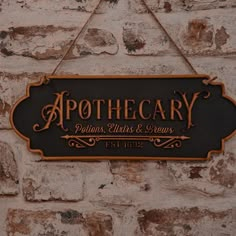 a sign that says apothecary against a white brick wall with gold lettering