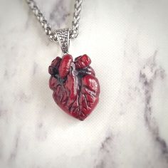 🖤 Embrace your dark elegance with my Handcrafted Realistic Heart Pendant Necklace 🖤 Indulge your Gothic sensibilities with this strikingly lifelike anatomical heart pendant, meticulously crafted by hand from rich, blood-red epoxy resin.  ✨ Product Details: * Material: Each pendant is carefully handcrafted from high-quality epoxy resin, capturing the essence of a real heart with its intricate details and deep, captivating color. * Chain: Paired with a durable stainless steel, braided style chai Realistic Heart Necklace, Anatomical Heart Pendant, Realistic Heart, Anatomical Heart Necklace, Real Heart, Resin Product, Dark Elegance, Anatomical Heart, Blood Red