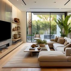 a living room filled with lots of furniture and a flat screen tv mounted on the wall