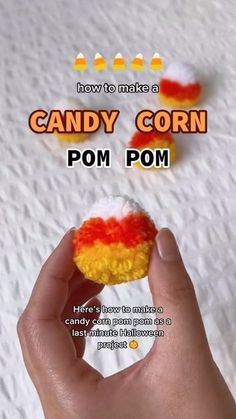 a hand holding a candy corn pom in front of a white background with the words how to make a candy corn pom