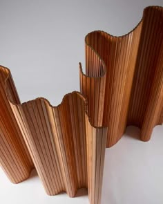 three pieces of wood stacked together on top of each other in the shape of wavy lines