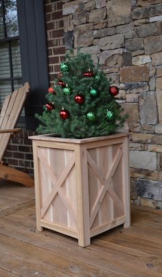 a small christmas tree in a wooden planter