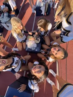 a group of cheerleaders eating cake together