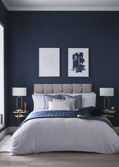 a bedroom with blue walls and white bedding