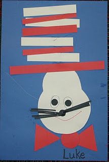 a paper cut out of a cat in the hat with red and white strips on it