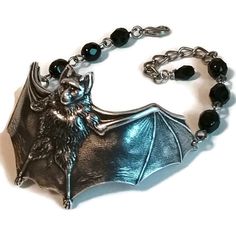 This cute bat bracelet was created using jet black Czech glass beads and antiqued silver plated brass!  They are a classic old school gothic style lovingly hand made by a genuine old school goth! ~ Jet black glass beads  ~ Metal components are antiqued silver brass ~ Bracelet measures 7-9 inches around with an extender chain VEXED JEWELRY: ONE-OF-A-KIND HANDCRAFTED PIECES MADE WITH LOVE, CARE, EXPERTISE & TOP QUALITY MATERIALS Gothic Silver Bracelets For Halloween, Silver Gothic Bracelets For Halloween, Old School Goth, Bat Bracelet, Gothic Glasses, Halloween Beads, Cute Bat, Beaded Cuff Bracelet, Brass Bracelet