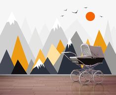 a baby's stroller in front of a mountain backdrop with birds flying over it