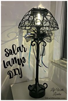 a lamp that is sitting on top of a table next to a window with the words solar lamp diy written on it