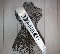 a white ribbon with the word smile on it sitting on top of a mannequin