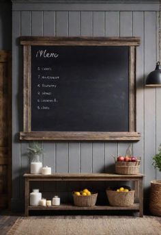 a chalkboard mounted to the side of a wall next to baskets of fruit and candles