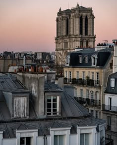 an image of a city skyline at sunset with the sun setting in the sky and buildings all around