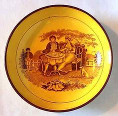 a yellow and brown plate with an image of two people sitting at a table