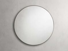 a round mirror hanging on the wall