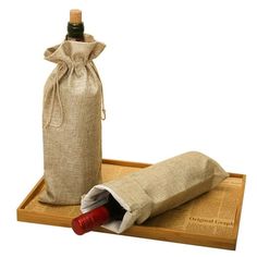 a wine bottle and cork on a wooden tray with burlap wrapping around it