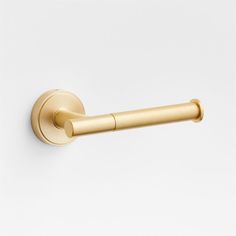 an image of a gold door handle on a white wall