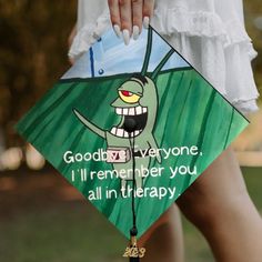 a woman holding a kite with an image of a cartoon character on it that says goodbye everyone i'll'll remember you all in therapy